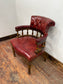Stunning red leather captain's chair with wooden spindle back