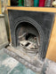 Old cast iron fireplace with decorative fender