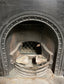 Old cast iron fireplace with decorative fender
