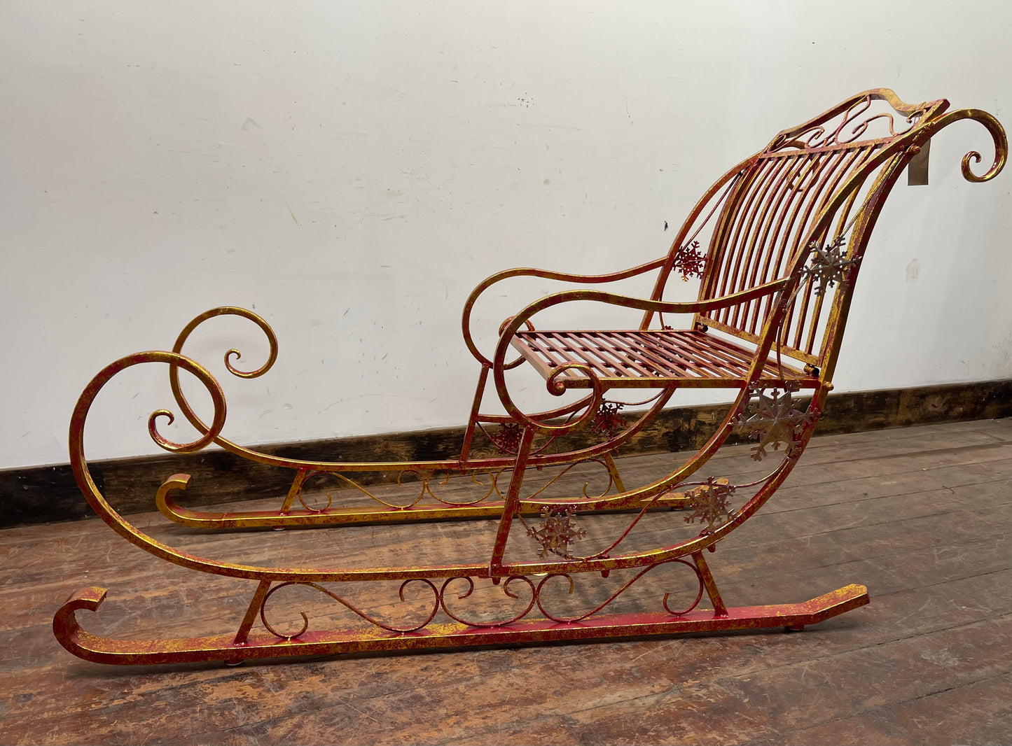 Large red and gold metal Christmas sleigh