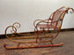 Large red and gold metal Christmas sleigh