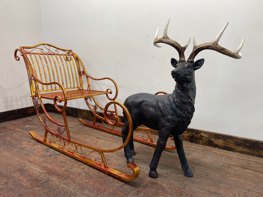 Red and gold Christmas sleigh including reindeer figure