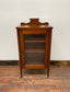 Small antique cabinet with glass door and castors