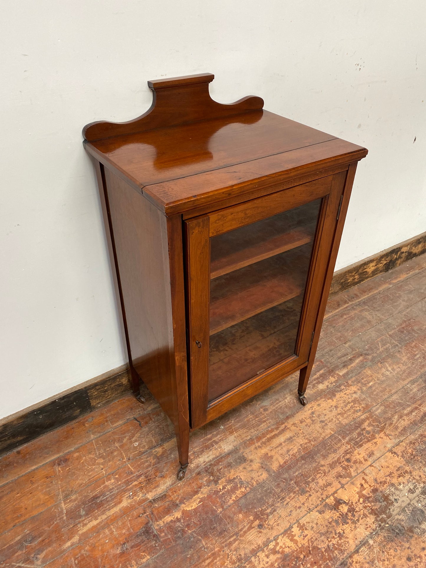 Small antique cabinet with glass door and castors