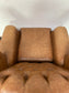 Tan leather wingback chair with patterned back