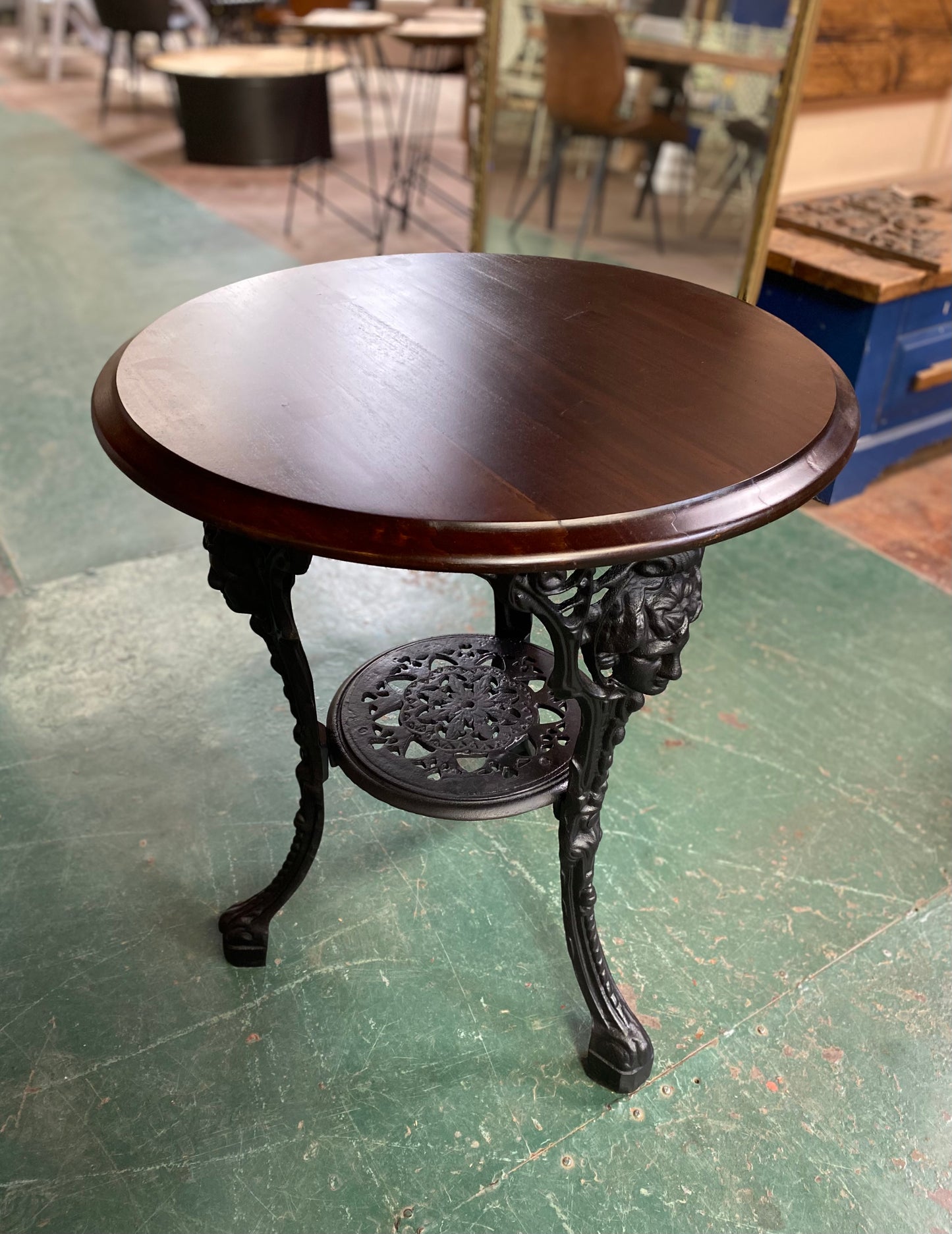 Cast iron pub table with 'lady face' and wooden top