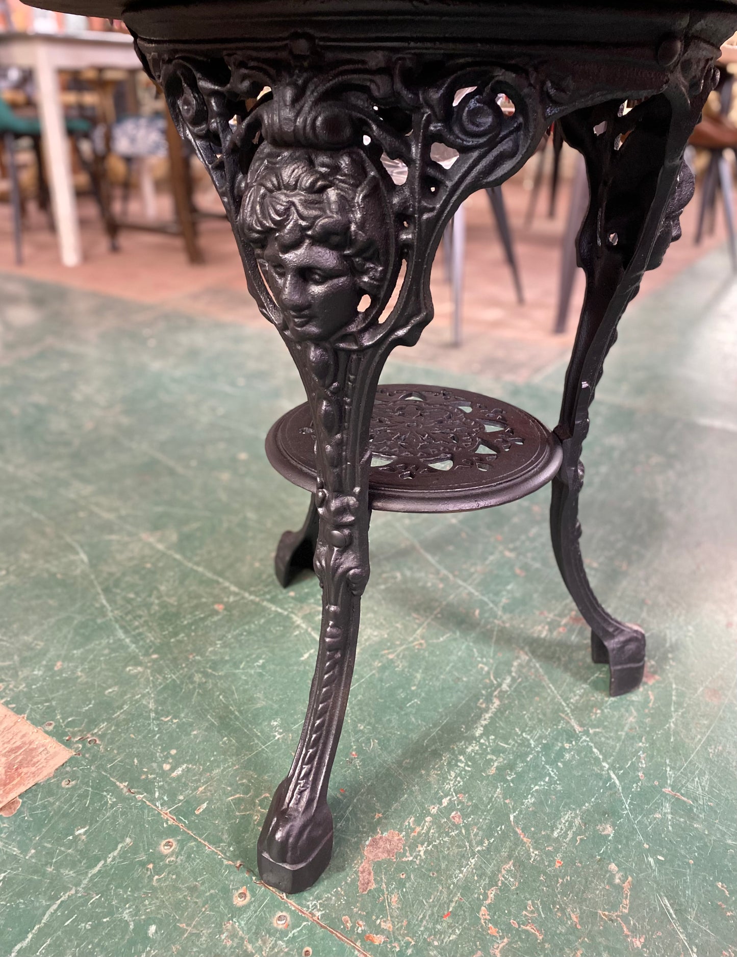 Cast iron pub table with 'lady face' and wooden top