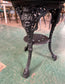 Cast iron pub table with 'lady face' and wooden top