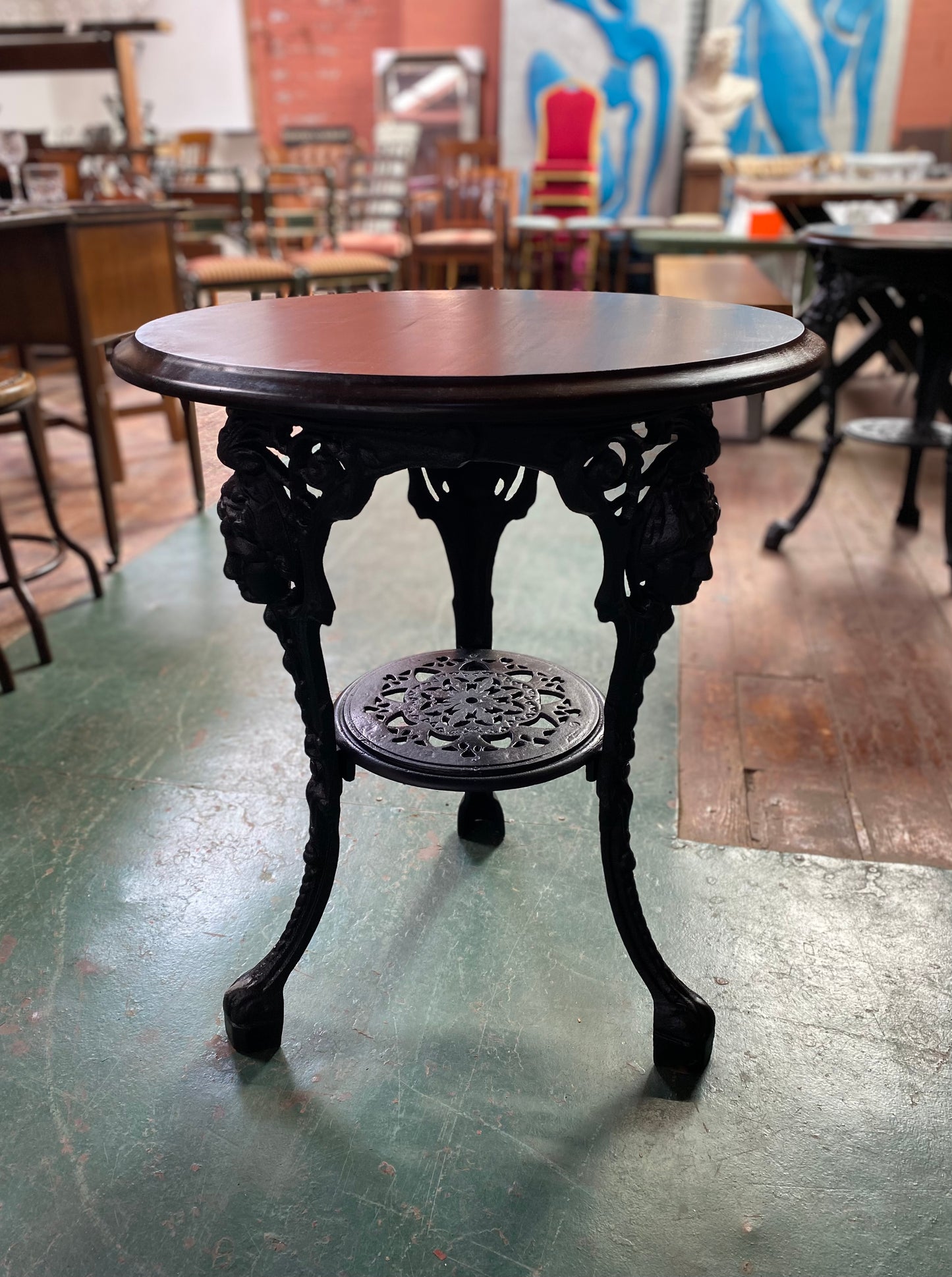 Cast iron pub table with 'lady face' and wooden top
