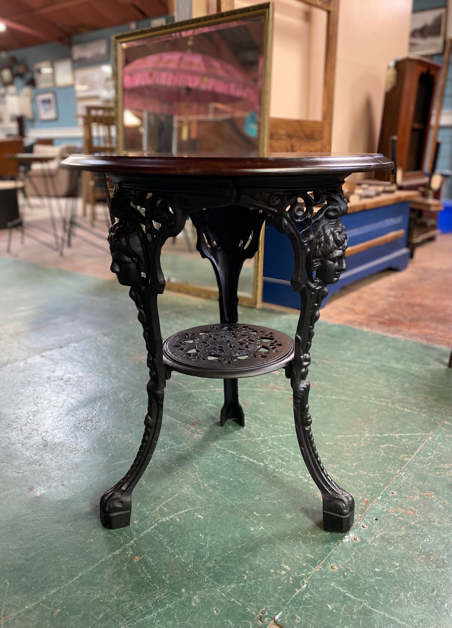 Cast iron pub table with 'lady face' and wooden top