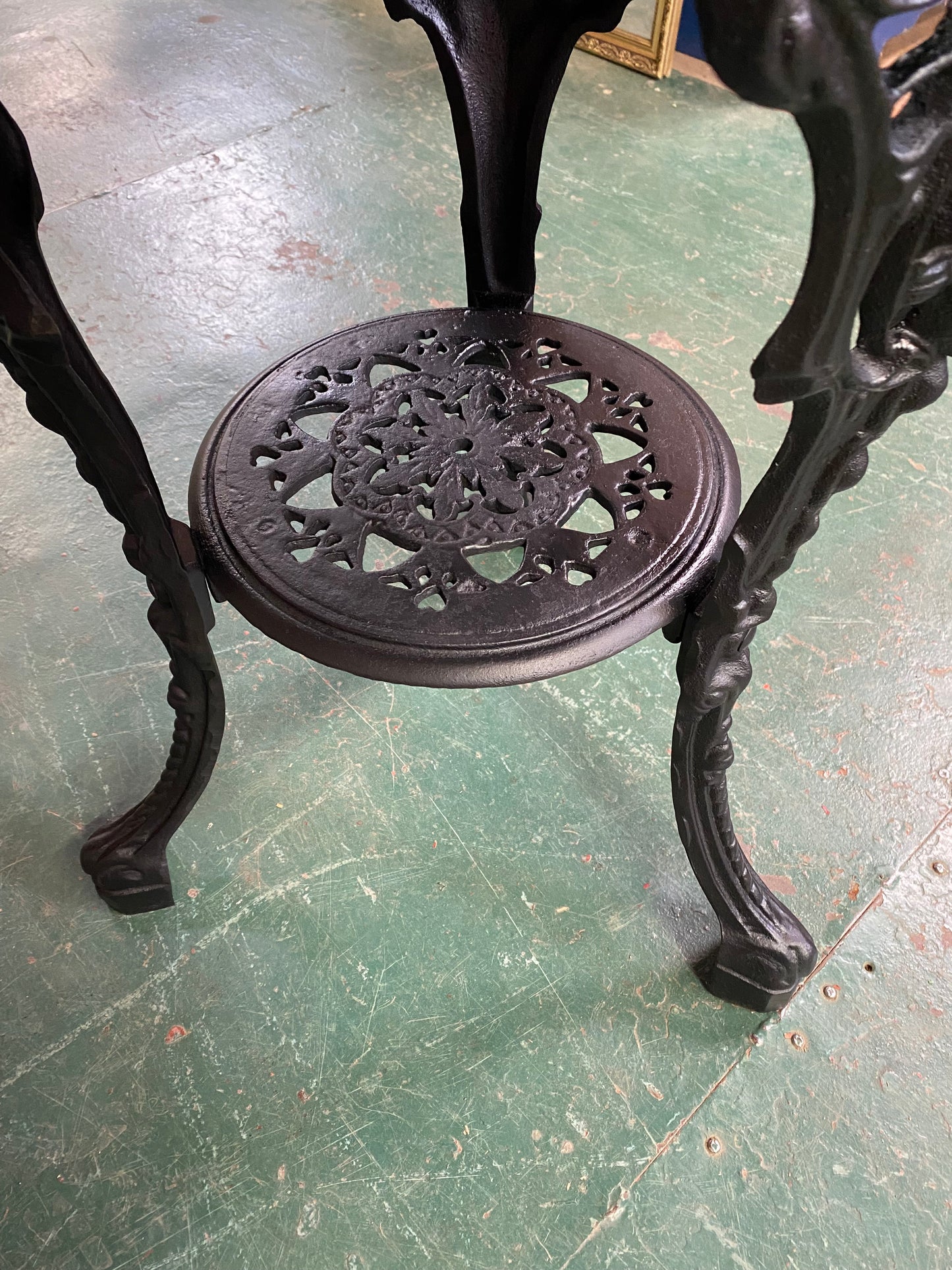 Cast iron pub table with 'lady face' and wooden top