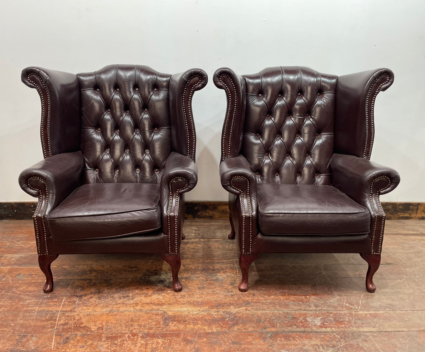 Stunning matching pair of brown leather wingback armchairs