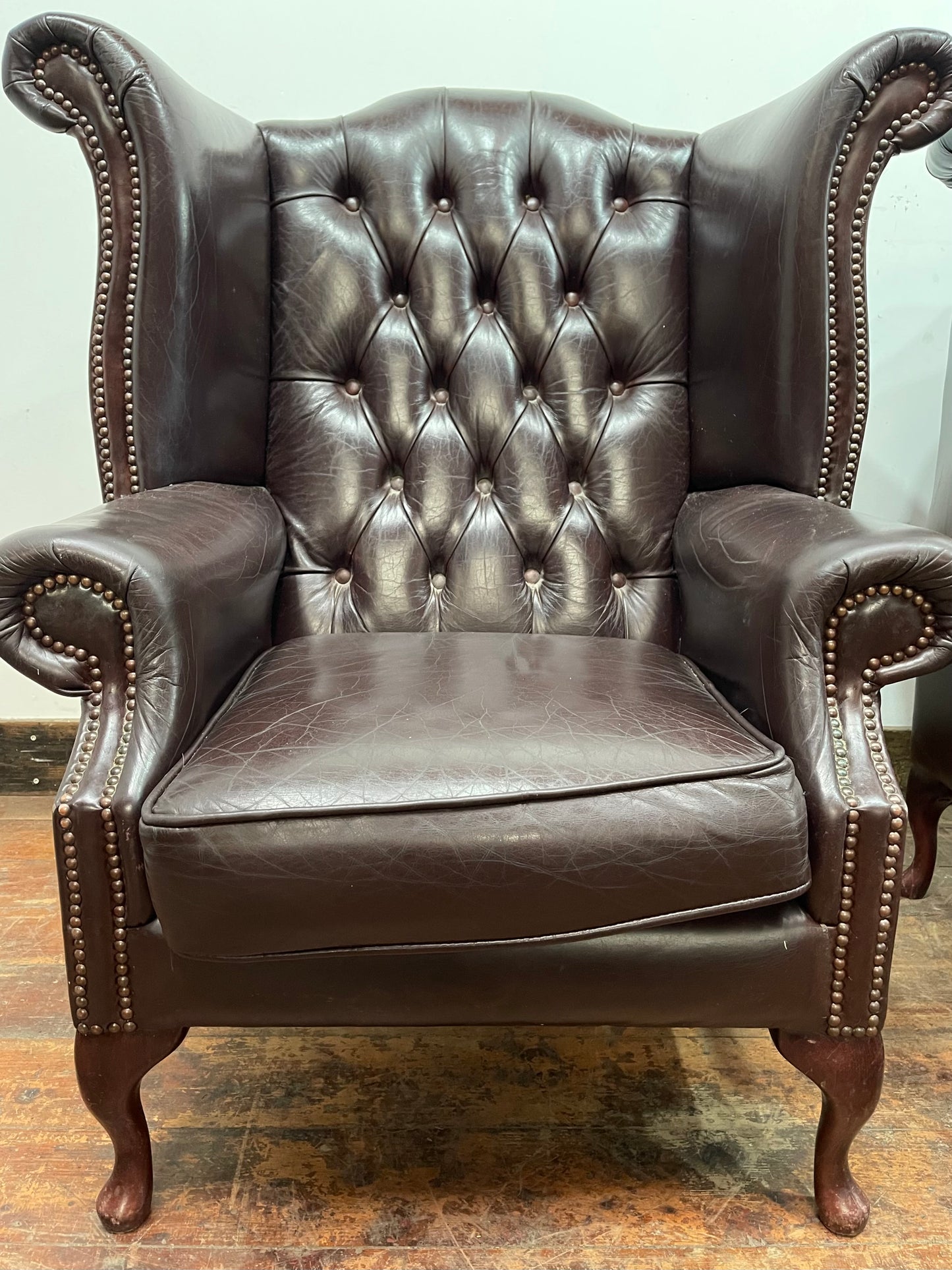 Stunning matching pair of brown leather wingback armchairs