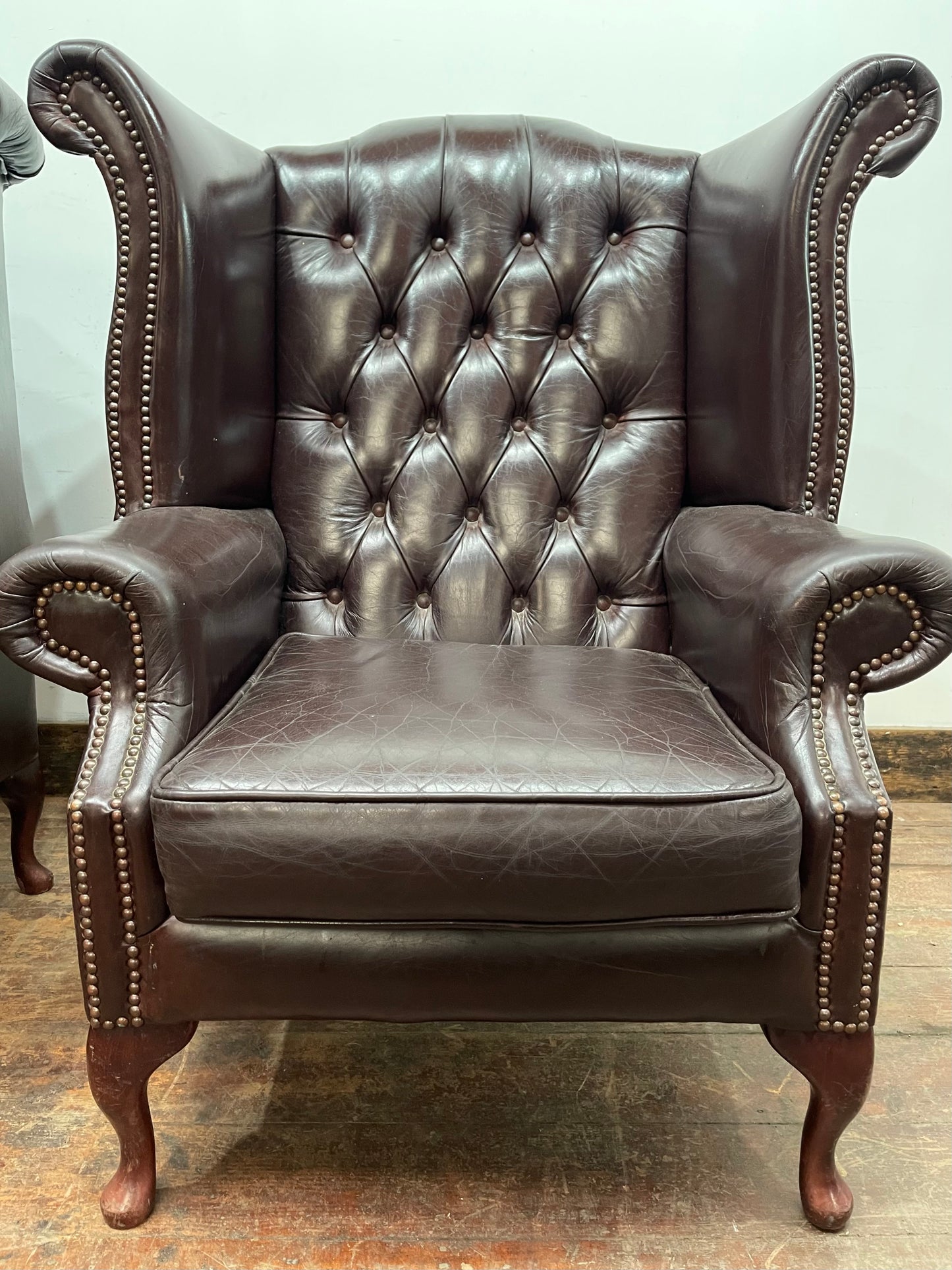 Stunning matching pair of brown leather wingback armchairs