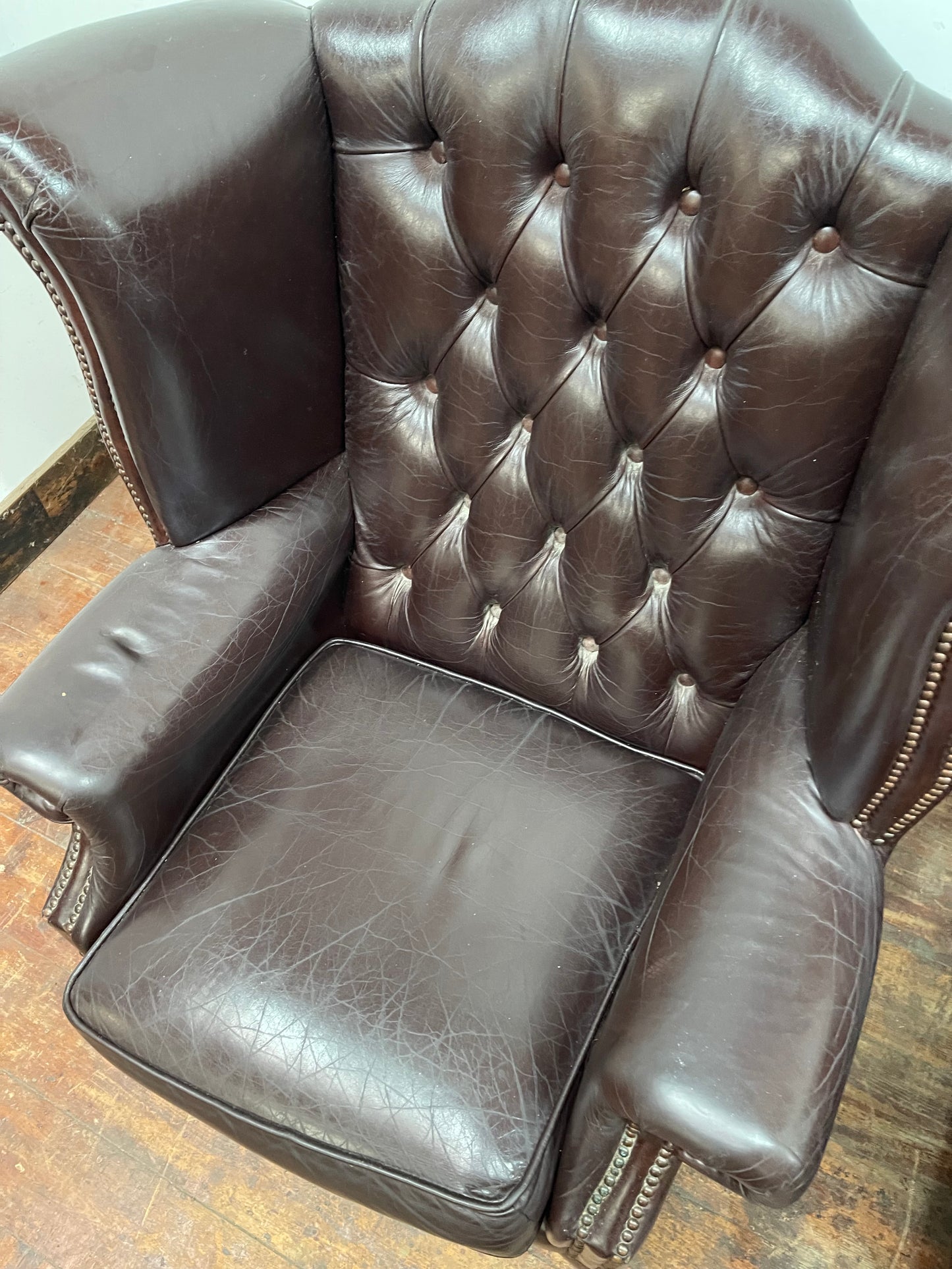 Stunning matching pair of brown leather wingback armchairs
