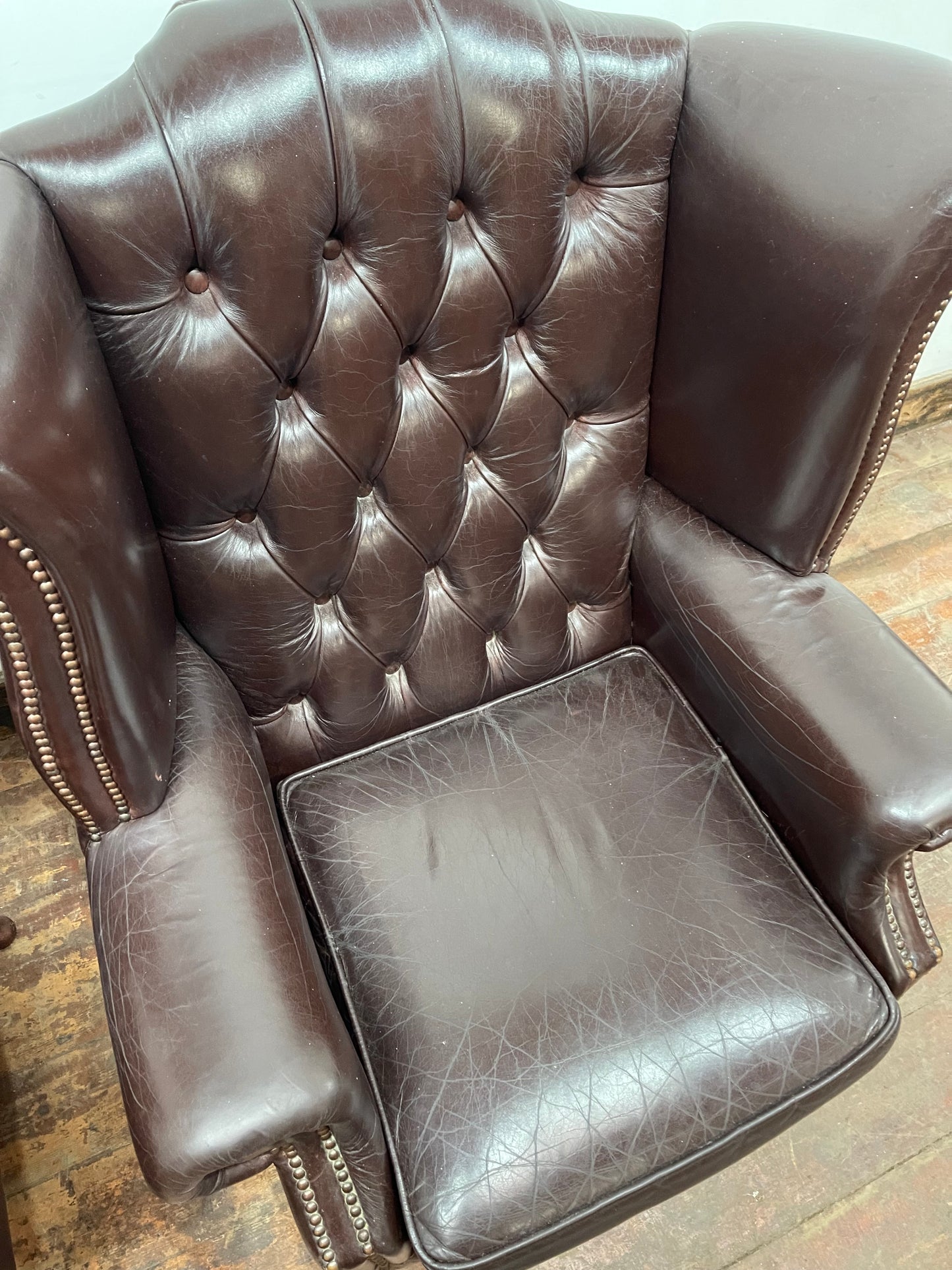 Stunning matching pair of brown leather wingback armchairs