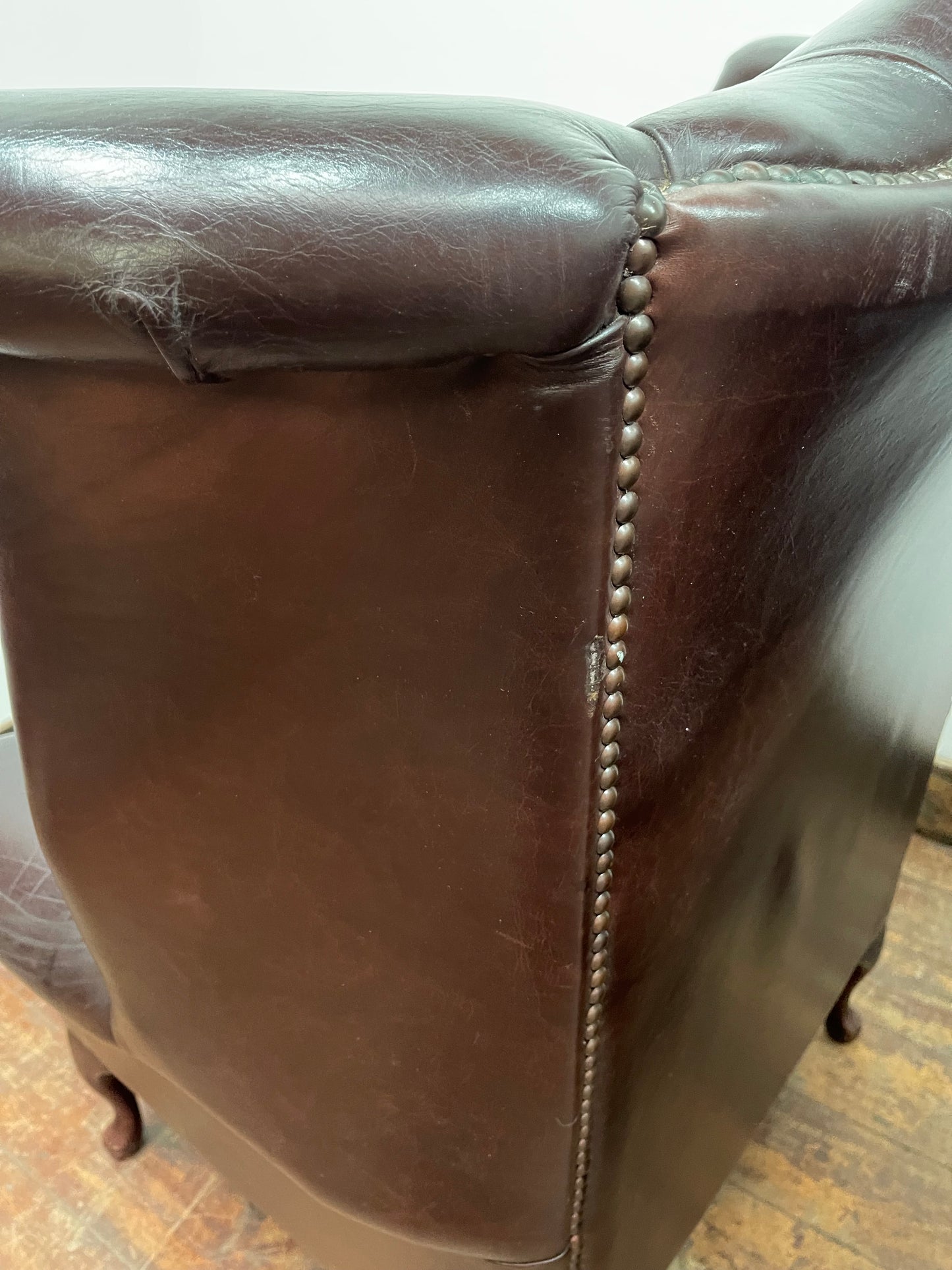 Stunning matching pair of brown leather wingback armchairs