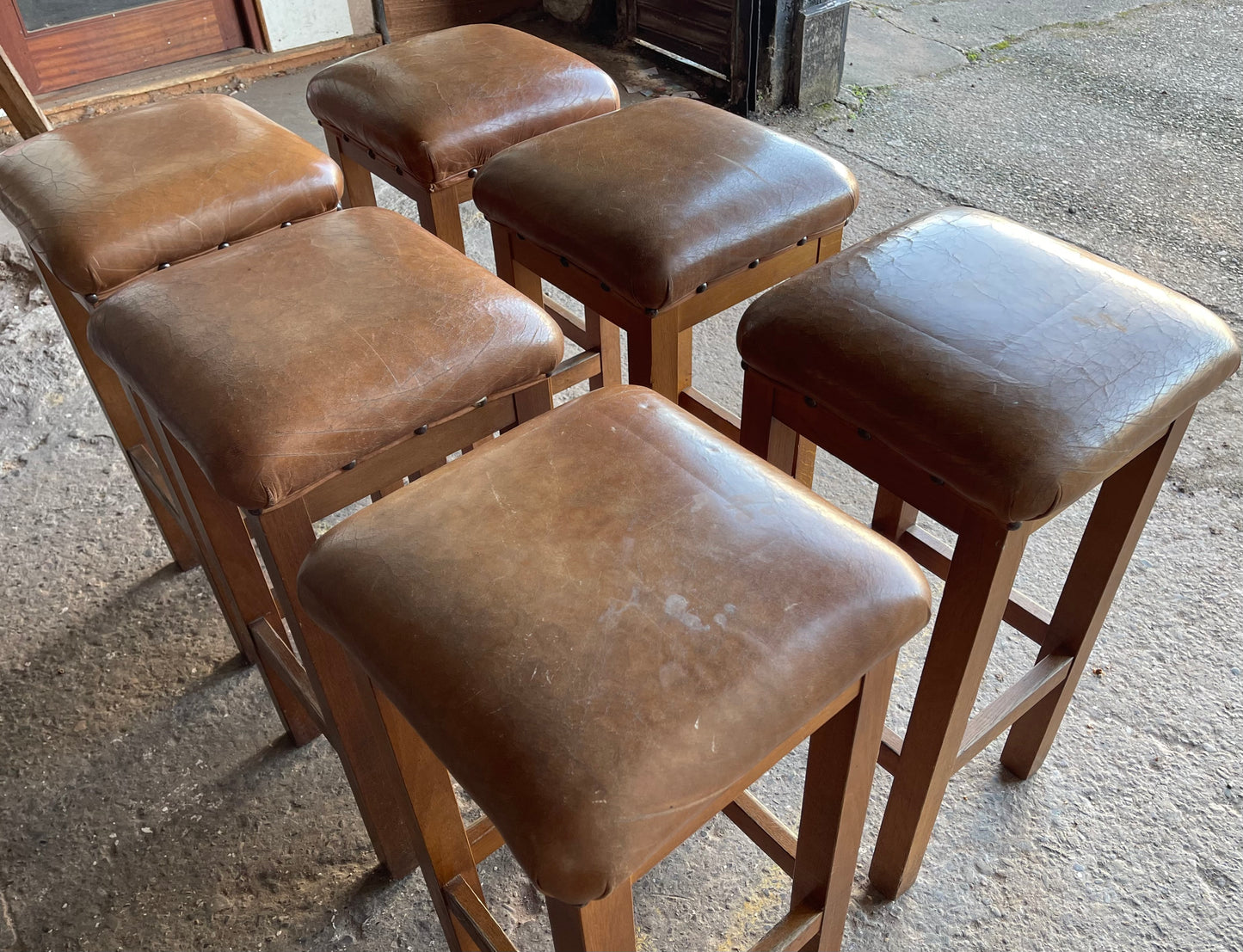 Matching set of 6 tan leather bar stools with square tops