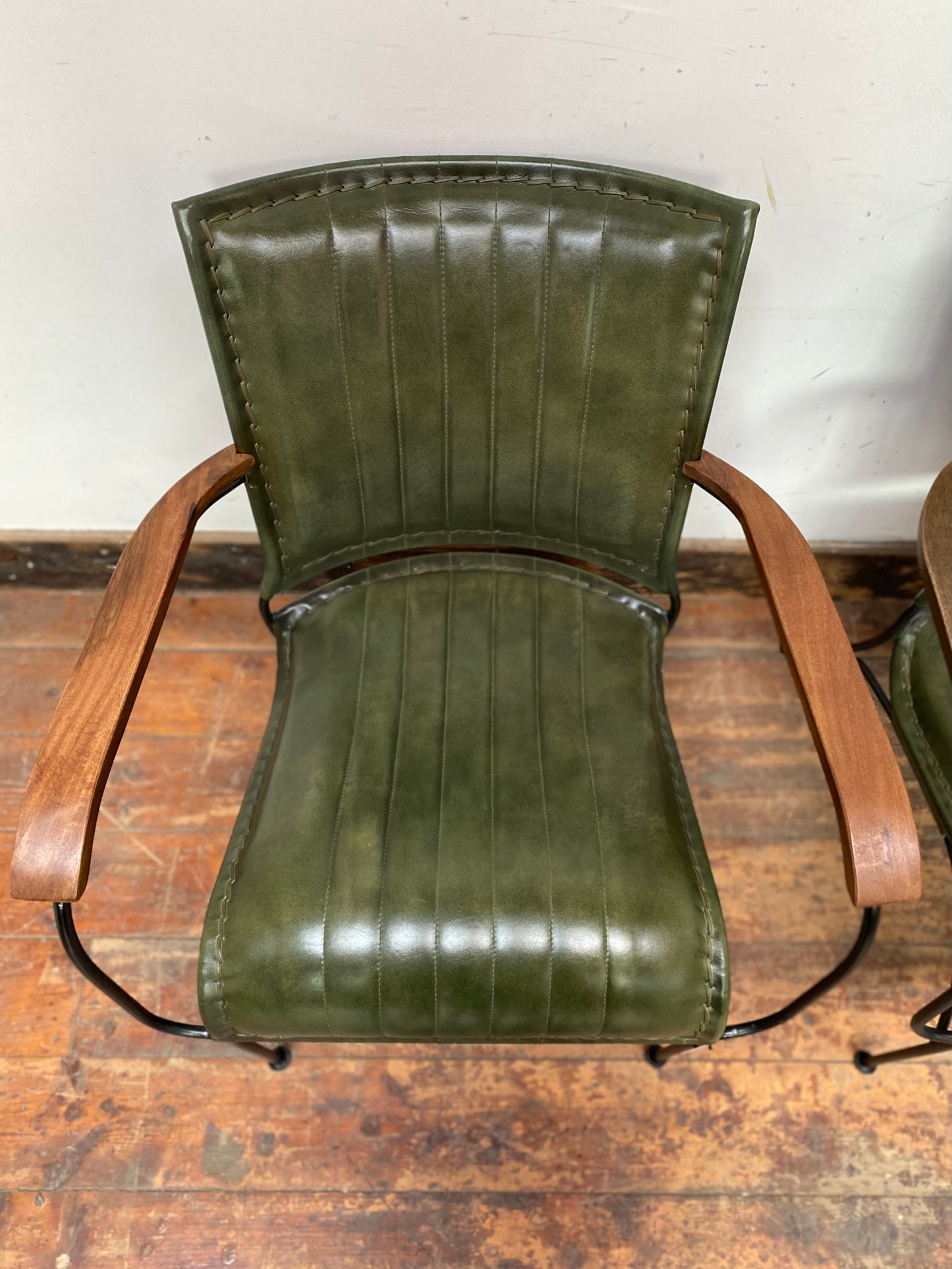 Pair of green leather armchairs with metal frame