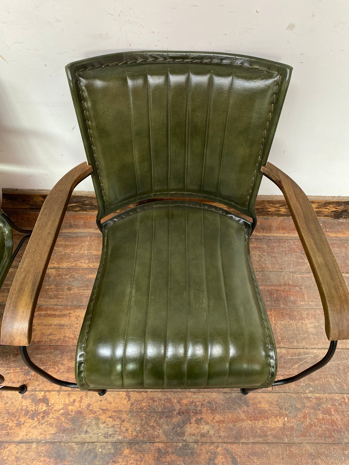 Pair of green leather armchairs with metal frame