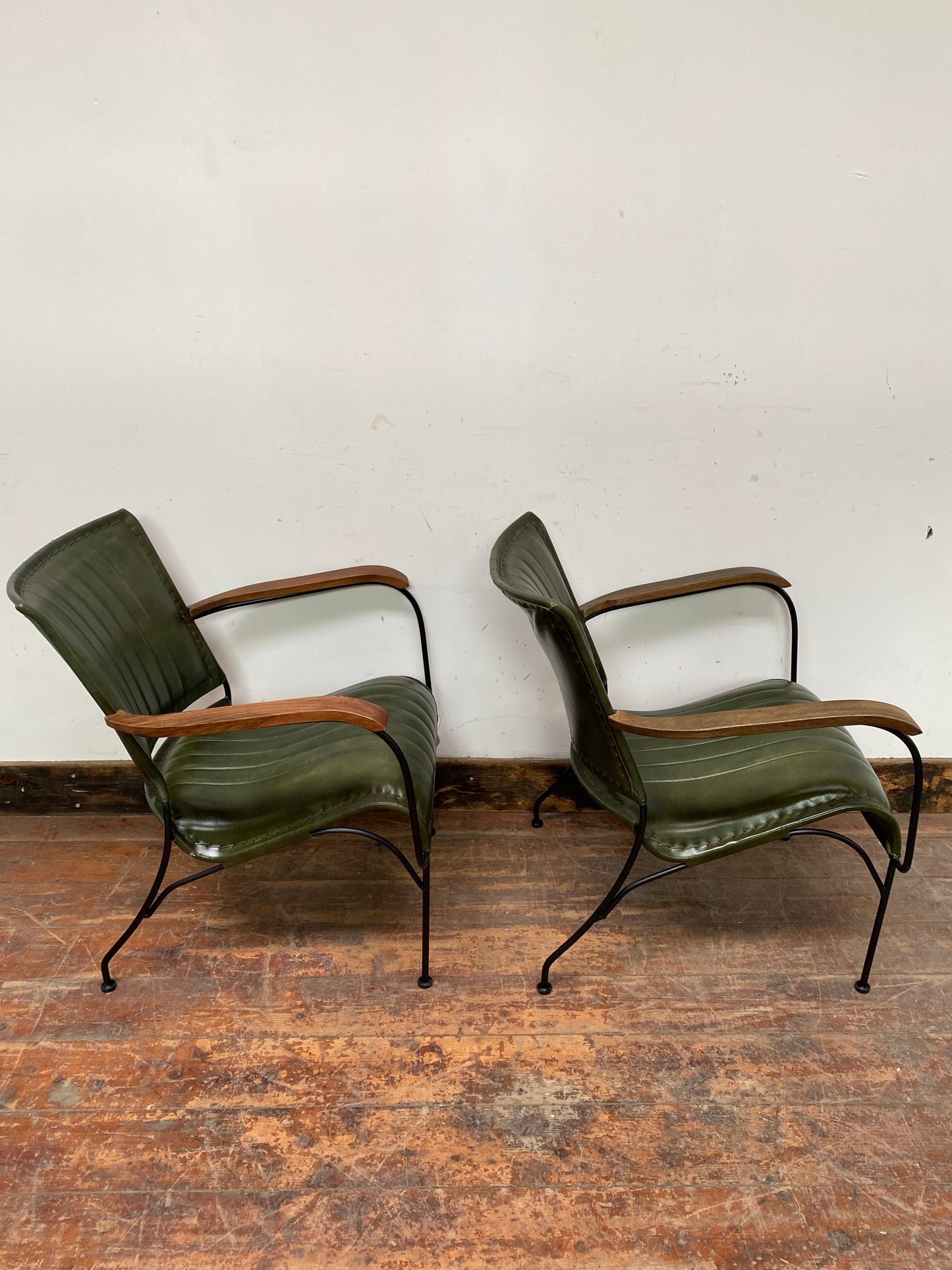 Pair of green leather armchairs with metal frame