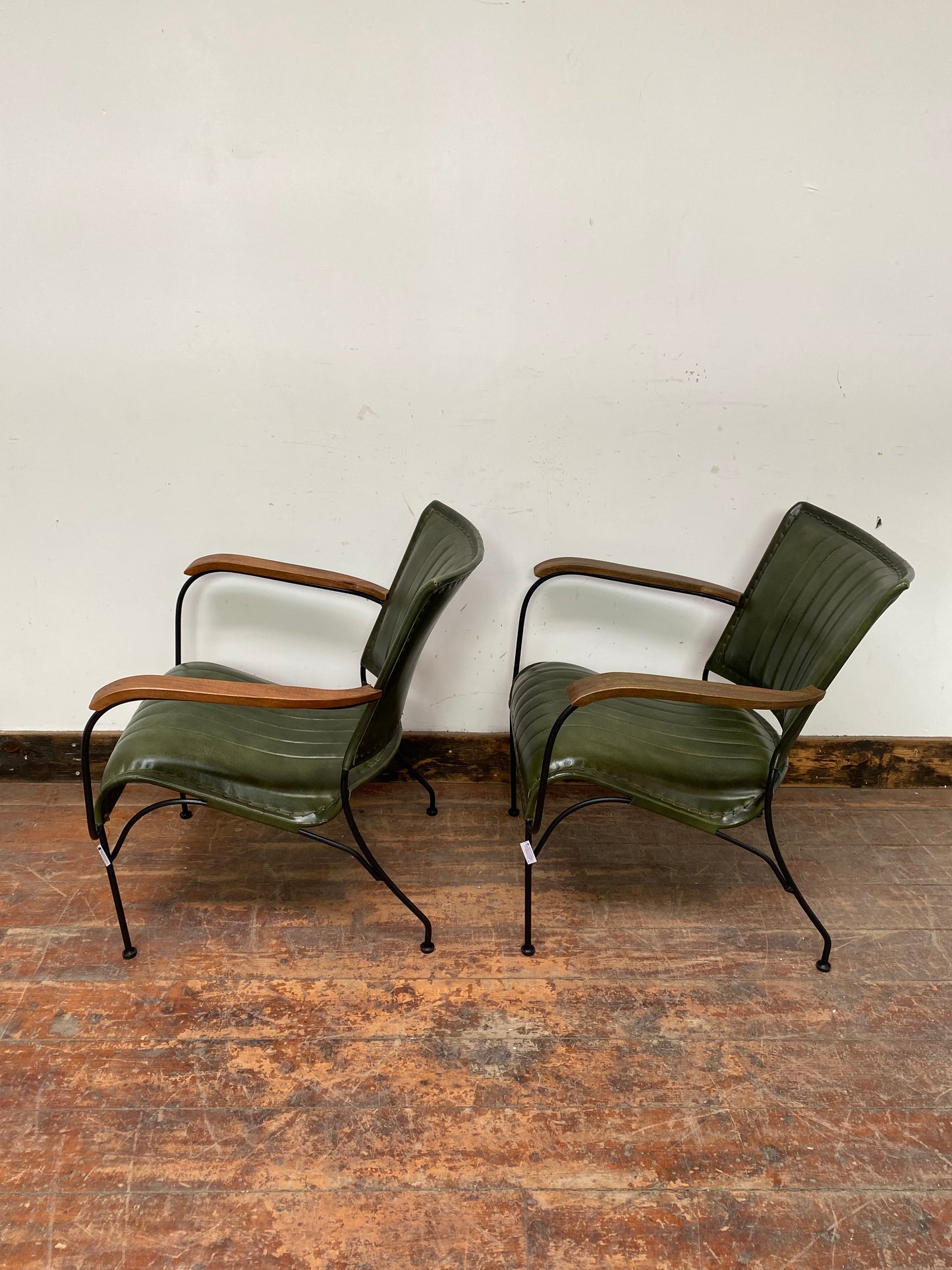 Pair of green leather armchairs with metal frame