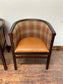 Pair of tan leather and check fabric tub chairs