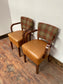 Pair of tan leather and check fabric chairs