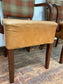 Pair of tan leather and check fabric chairs