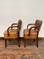 Pair of tan leather and check fabric chairs