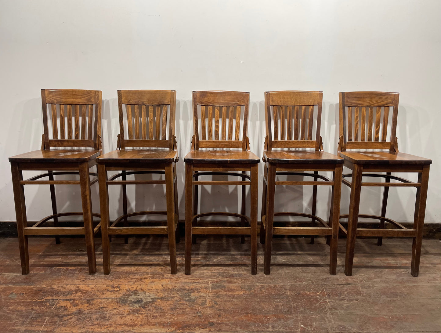 Set of five wooden pub bar stools with backrests
