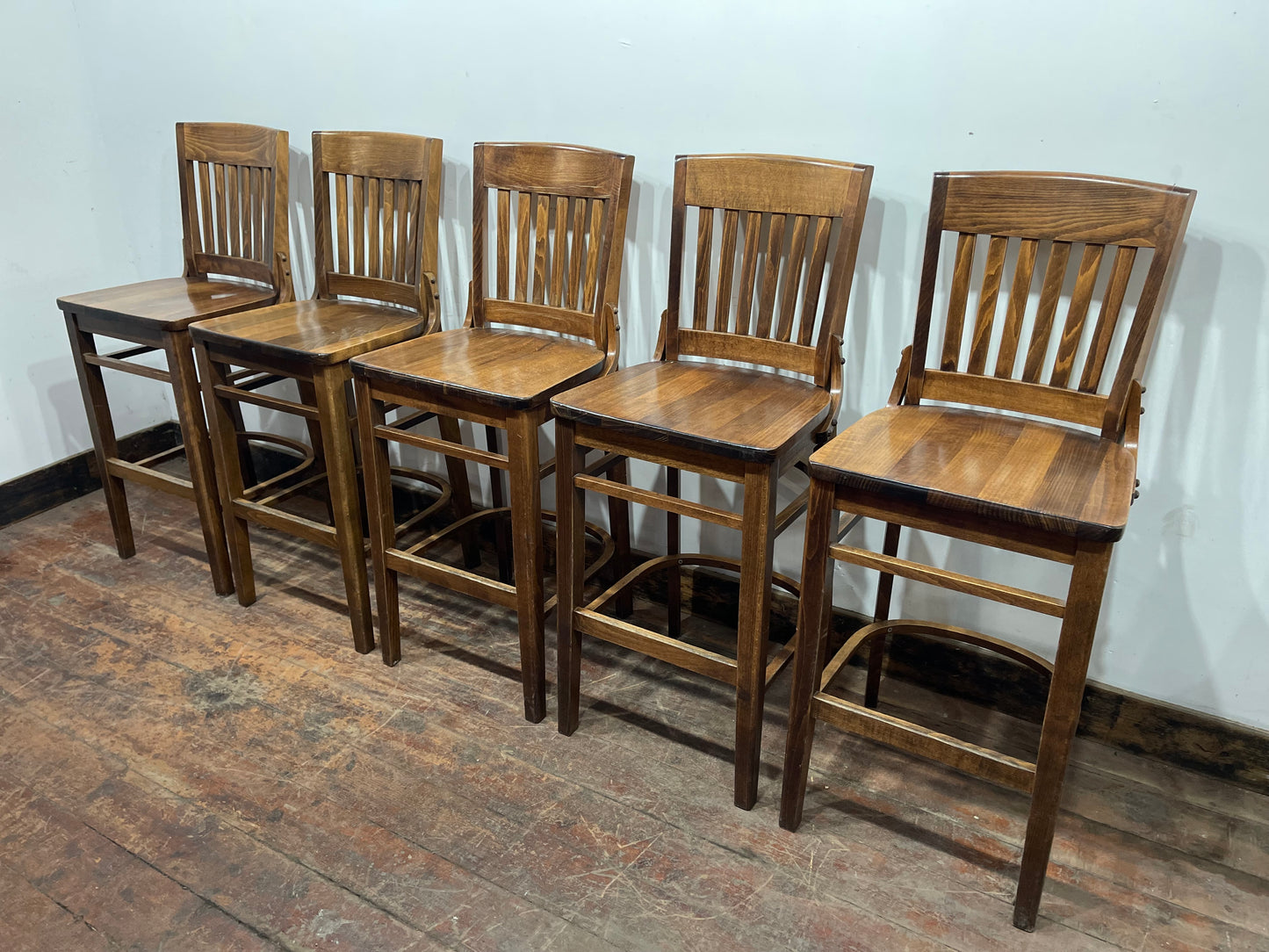 Set of five wooden pub bar stools with backrests