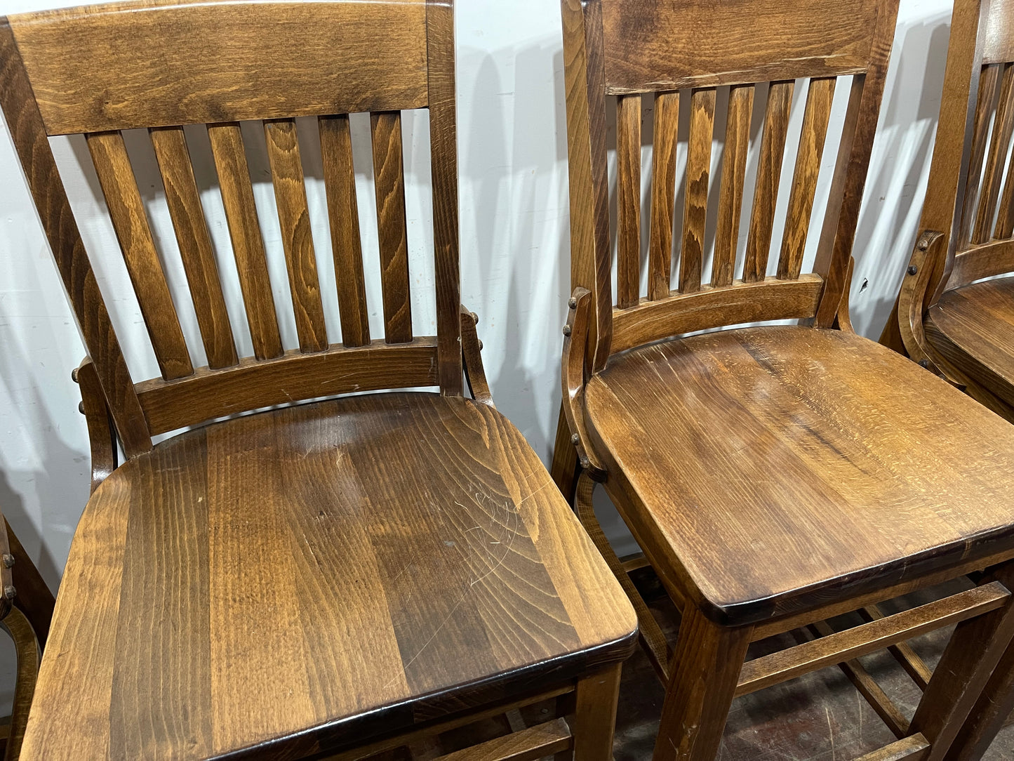 Set of five wooden pub bar stools with backrests