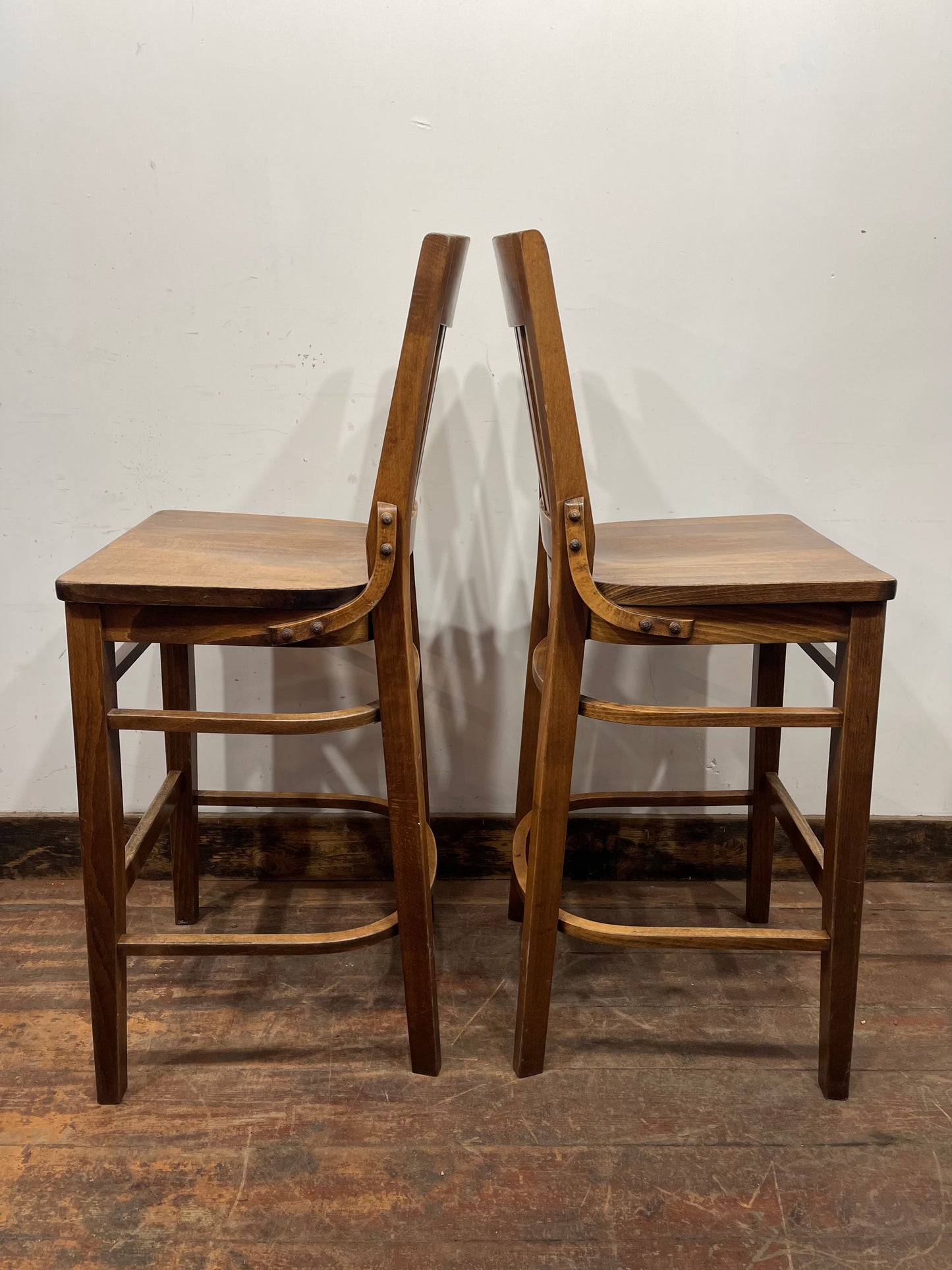 Set of five wooden pub bar stools with backrests