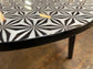 Black and white round coffee table with graphic print