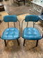 Pair of blue faux-leather chairs and black round table