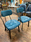 Pair of blue faux-leather chairs and black round table