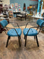 Pair of blue faux-leather chairs and black round table
