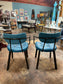 Pair of blue faux-leather chairs and black round table
