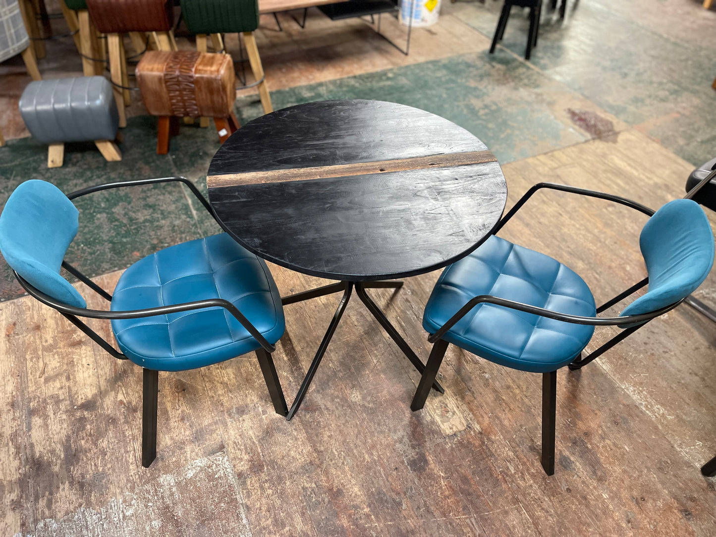Pair of blue faux-leather chairs and black round table