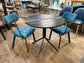 Pair of blue faux-leather chairs and black round table