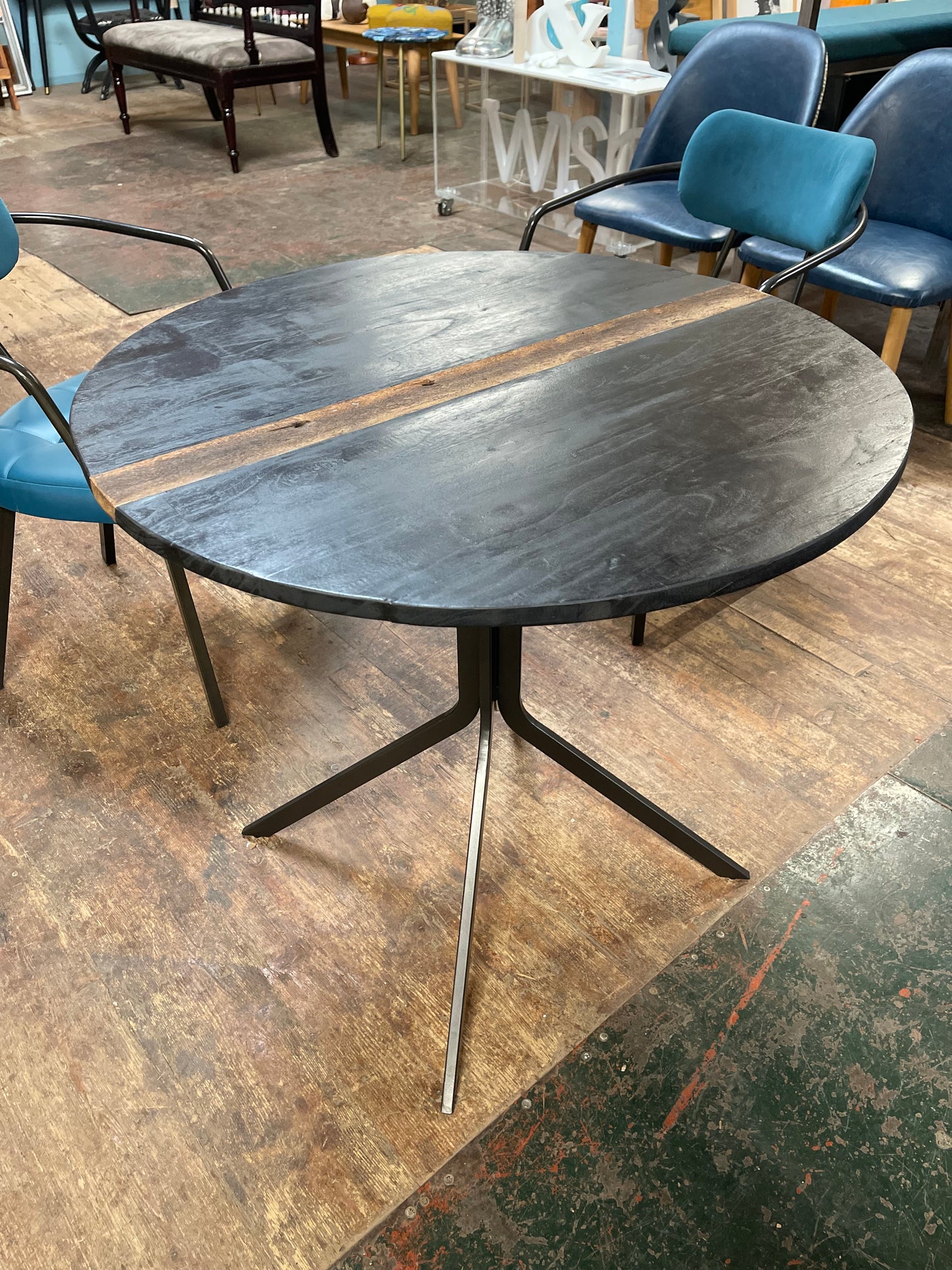Pair of blue faux-leather chairs and black round table