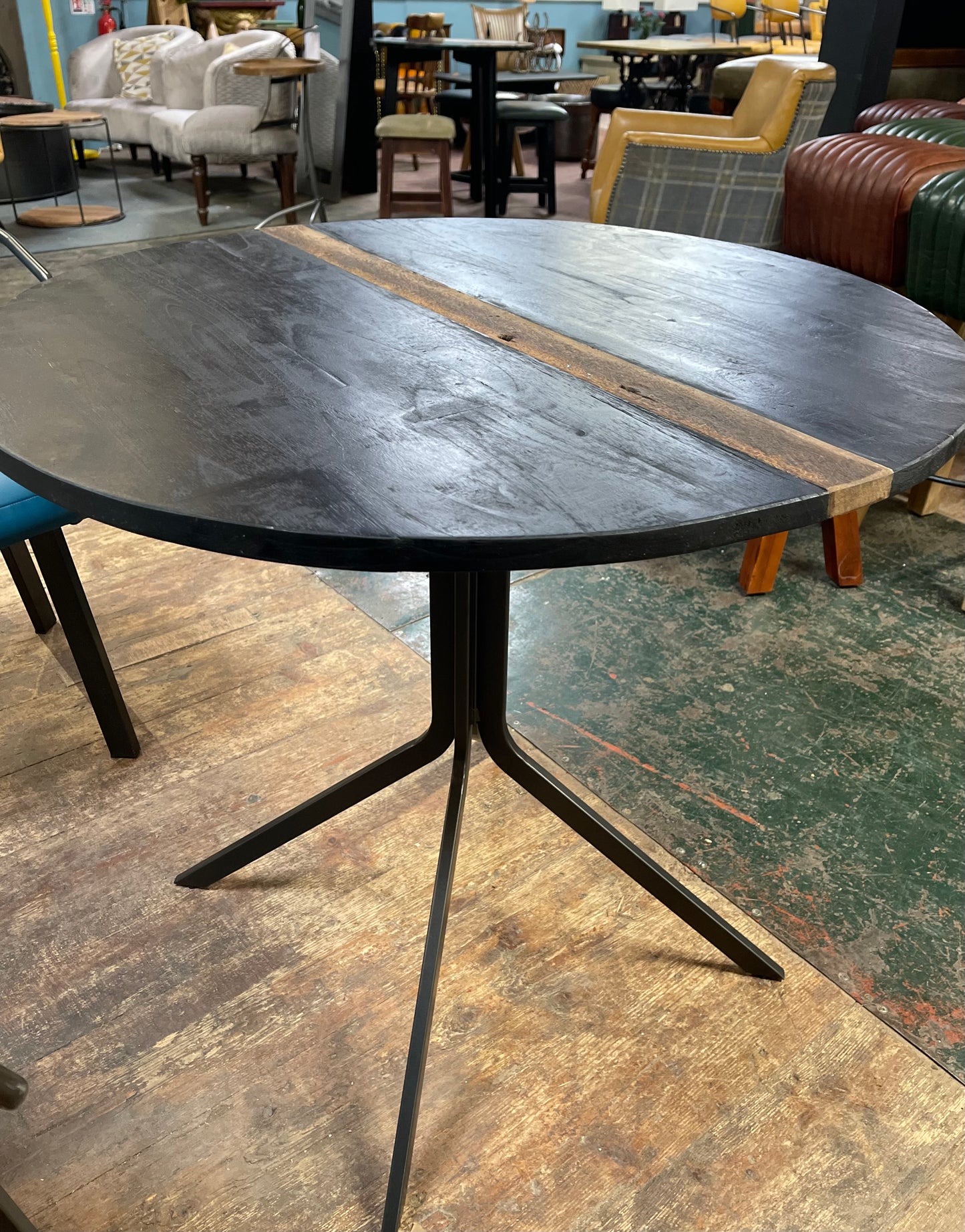 Pair of blue faux-leather chairs and black round table