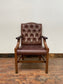 Brown leather armchair with wood frame