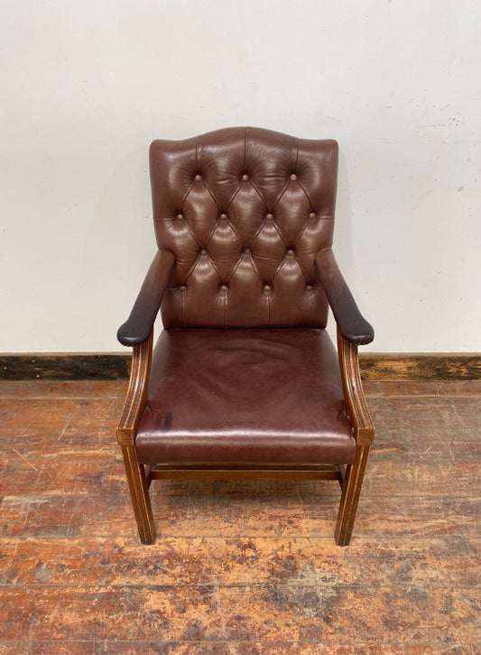 Brown leather armchair with wood frame