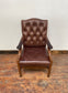 Brown leather armchair with wood frame