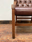 Brown leather armchair with wood frame