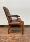 Brown leather armchair with wood frame