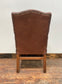 Brown leather armchair with wood frame