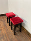 Low bar stools with red velvet-feel tops